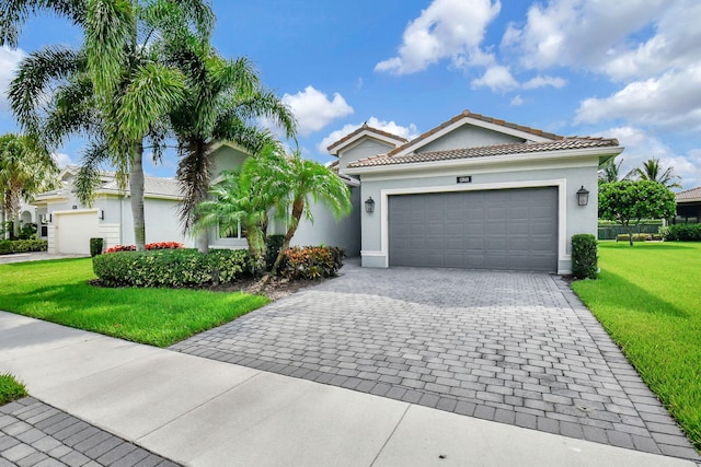 mediterranean / spanish home with a garage and a front lawn