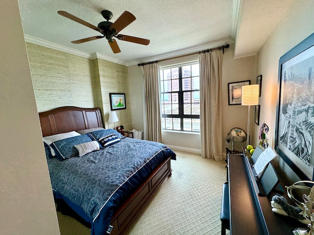 bedroom featuring a textured ceiling, carpet flooring, ornamental molding, and ceiling fan