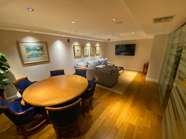 dining space with wood-type flooring