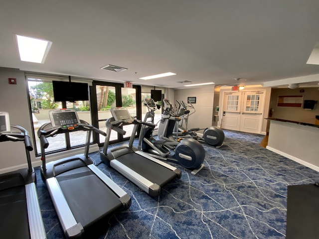 exercise room with dark colored carpet