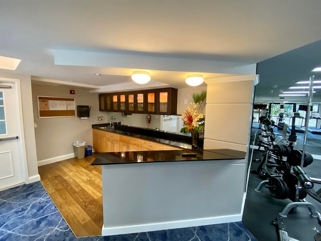 kitchen with hardwood / wood-style floors and kitchen peninsula