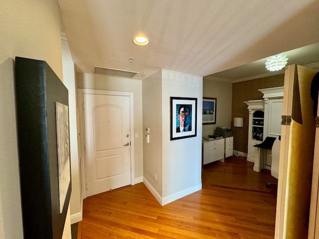 hall featuring ornamental molding and light wood-type flooring