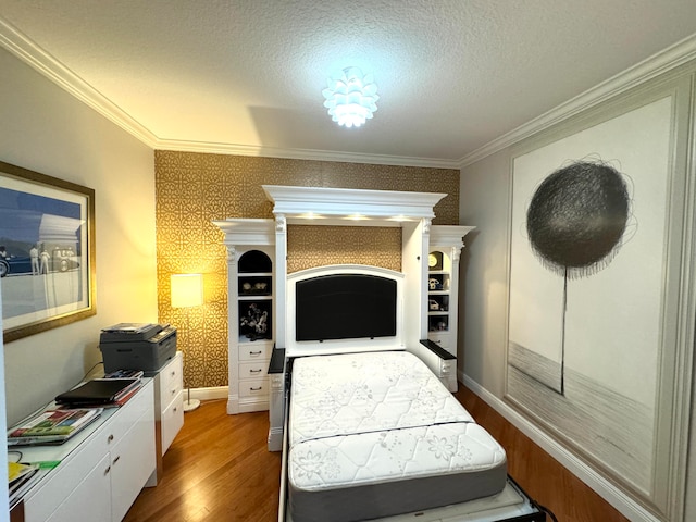 bedroom featuring crown molding, hardwood / wood-style flooring, and a textured ceiling