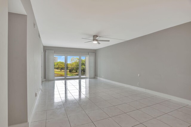 spare room featuring ceiling fan and light tile patterned floors