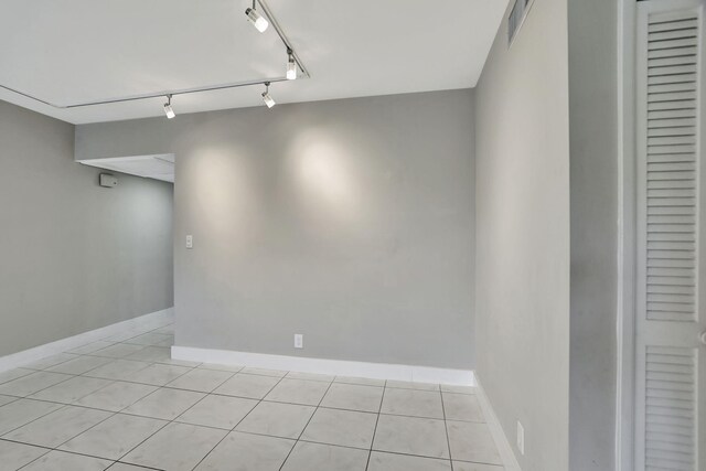 unfurnished room featuring french doors and light tile patterned floors