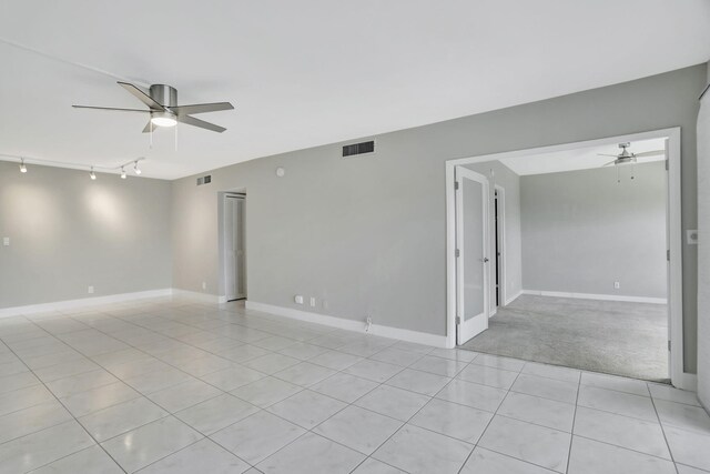 unfurnished room with ceiling fan and light colored carpet