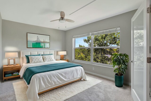 unfurnished bedroom featuring carpet, french doors, a walk in closet, ensuite bath, and ceiling fan