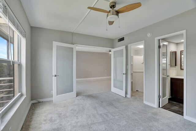 walk in closet with light colored carpet