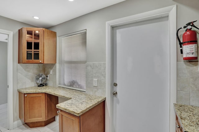 kitchen featuring light stone counters and light tile patterned flooring