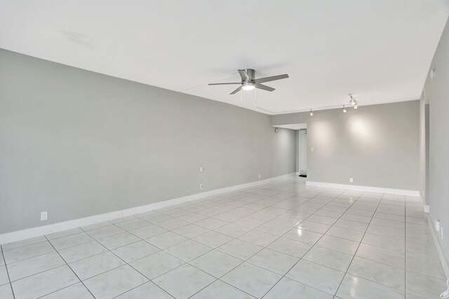 spare room with light tile patterned flooring and track lighting