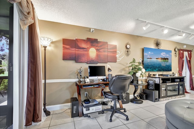 tiled office space with a textured ceiling and rail lighting