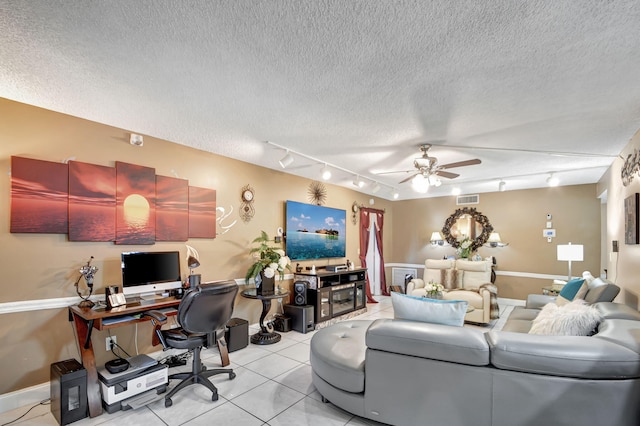 tiled living room with ceiling fan, a textured ceiling, and track lighting