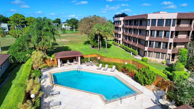 view of pool with a patio and a yard