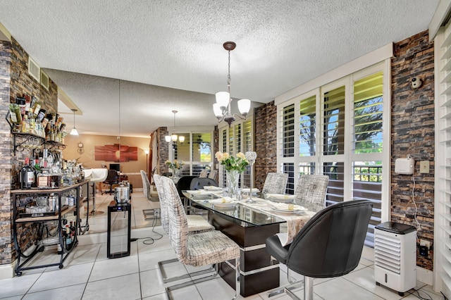 tiled dining room featuring an inviting chandelier and a textured ceiling