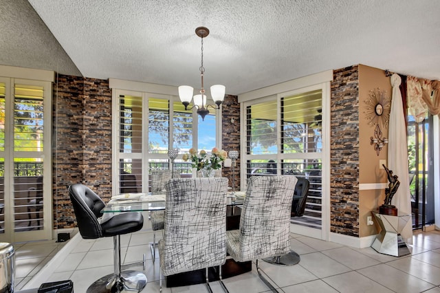 unfurnished dining area with an inviting chandelier, a textured ceiling, and light tile floors