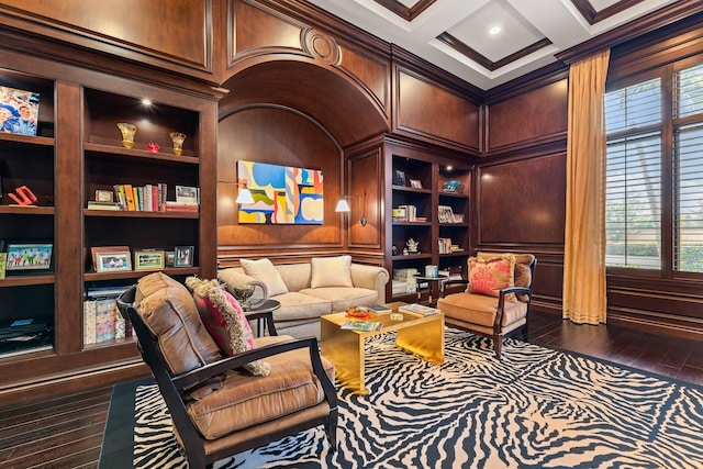 sitting room featuring coffered ceiling, built in shelves, crown molding, and dark wood-type flooring