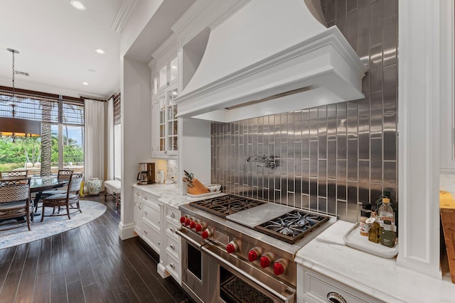 kitchen with hanging light fixtures, tasteful backsplash, crown molding, white cabinetry, and double oven range