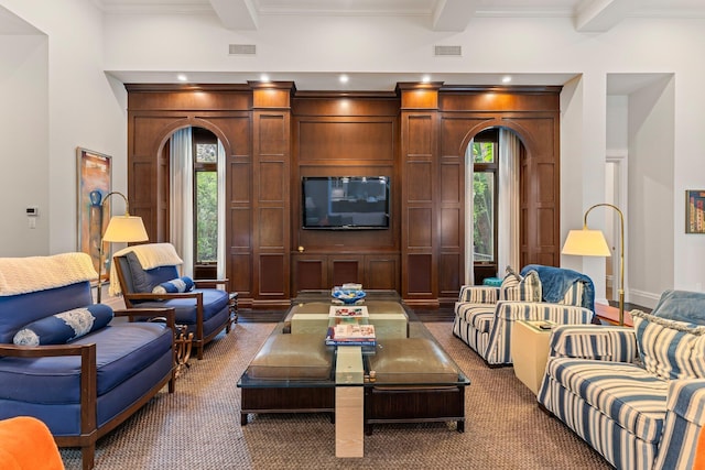 living room featuring beamed ceiling, plenty of natural light, dark hardwood / wood-style floors, and crown molding