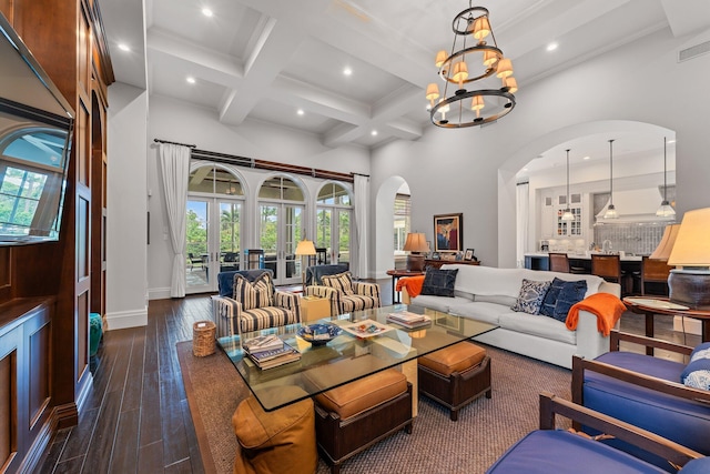 living room with dark hardwood / wood-style floors, coffered ceiling, beamed ceiling, and a wealth of natural light