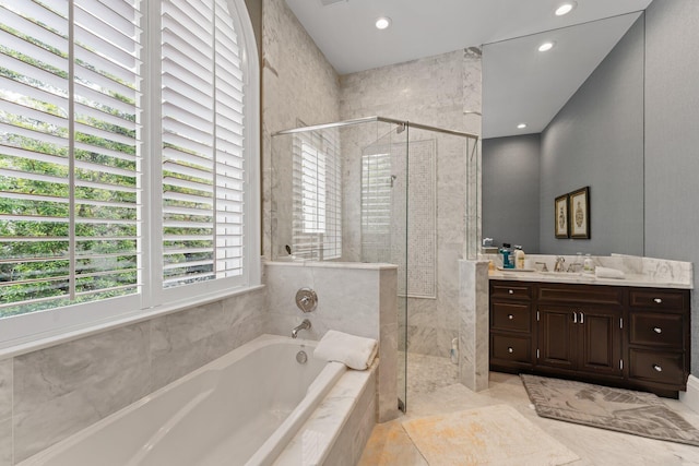 bathroom featuring tile flooring, independent shower and bath, and vanity with extensive cabinet space