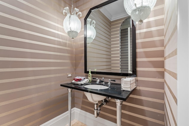 bathroom featuring crown molding and sink