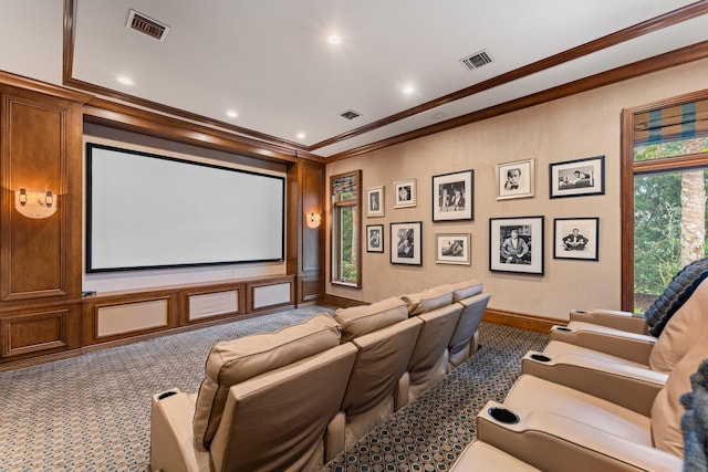 home theater with dark carpet and crown molding