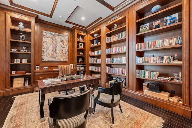 home office featuring hardwood / wood-style floors and built in shelves