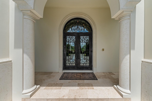 view of exterior entry featuring french doors