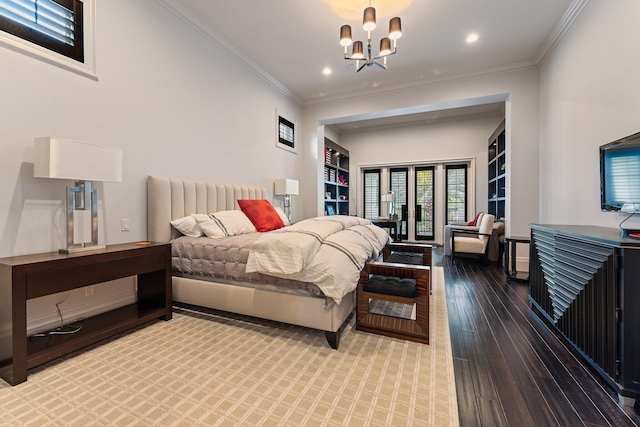 bedroom featuring a notable chandelier, ornamental molding, and wood-type flooring