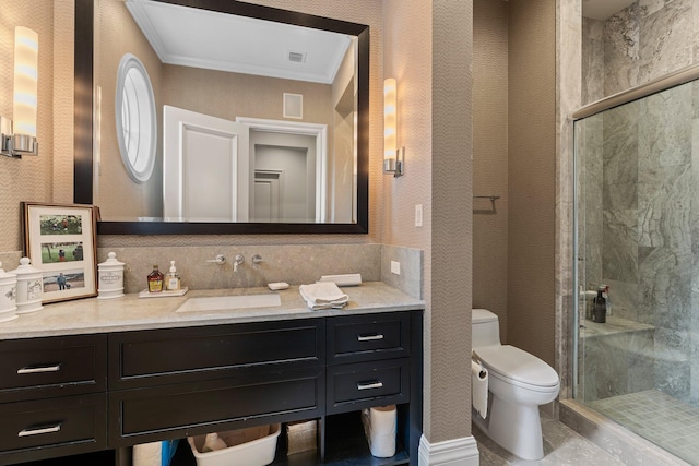 bathroom featuring a shower with shower door, crown molding, vanity, and toilet