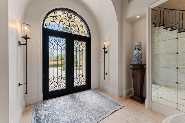 tiled foyer featuring french doors