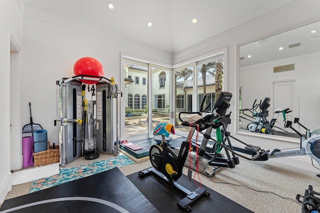 exercise room with carpet and ornamental molding