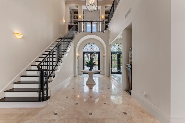 tiled foyer entrance with a high ceiling