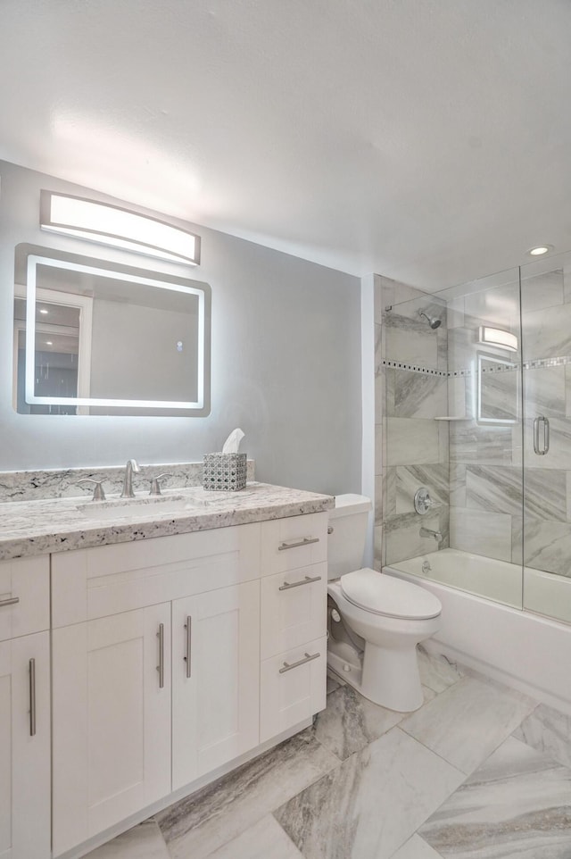 full bathroom with vanity, toilet, and bath / shower combo with glass door