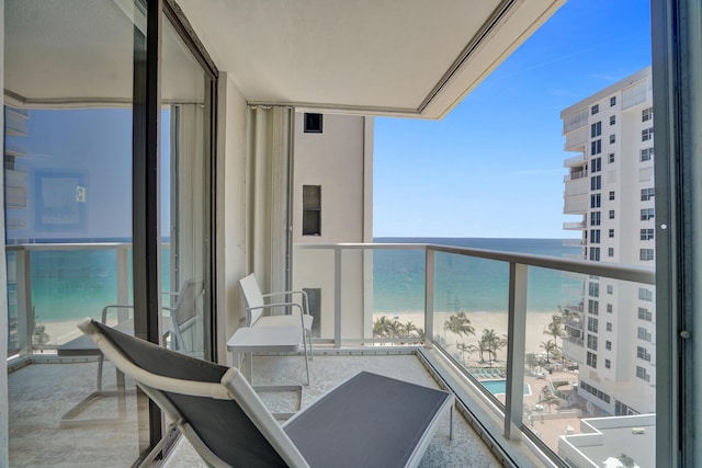 balcony with a beach view and a water view