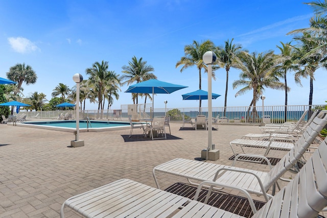 view of patio / terrace with a water view and a community pool