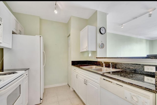 kitchen featuring white cabinets, rail lighting, and white appliances