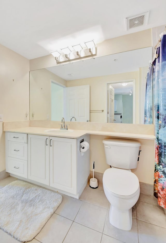 bathroom with tile patterned floors, vanity, and toilet