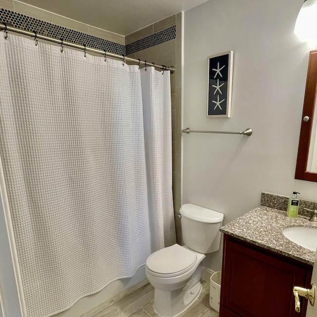 bathroom featuring tile floors, toilet, and vanity