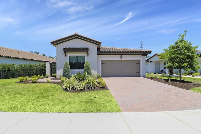 mediterranean / spanish-style home featuring a garage and a front yard