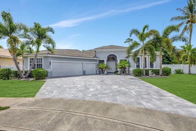 view of front of house featuring a garage and a front yard