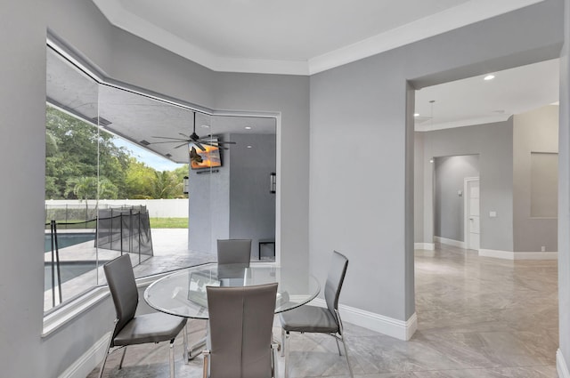 dining area featuring ceiling fan and ornamental molding