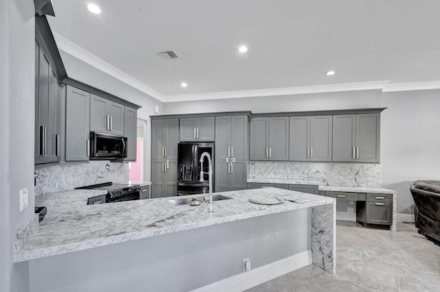 kitchen with kitchen peninsula, backsplash, gray cabinets, and black appliances