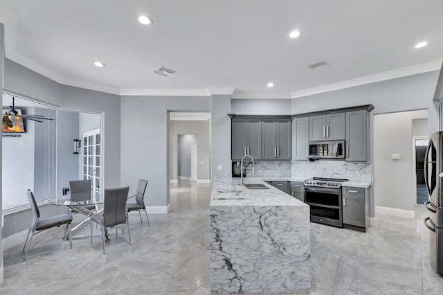 kitchen featuring crown molding, sink, gray cabinets, tasteful backsplash, and stainless steel appliances