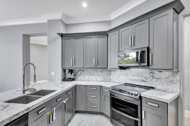 kitchen featuring gray cabinetry, light stone countertops, sink, and appliances with stainless steel finishes