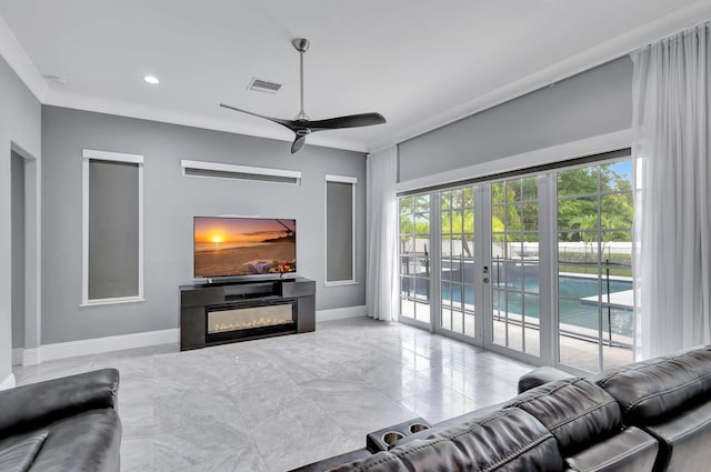 living room with french doors, plenty of natural light, crown molding, and ceiling fan