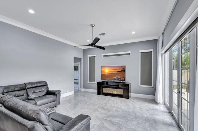 living room with ceiling fan and crown molding