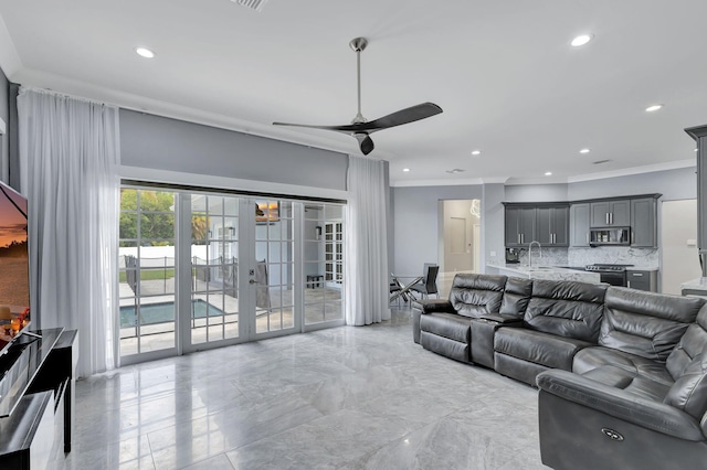 living room featuring ceiling fan, french doors, crown molding, and sink