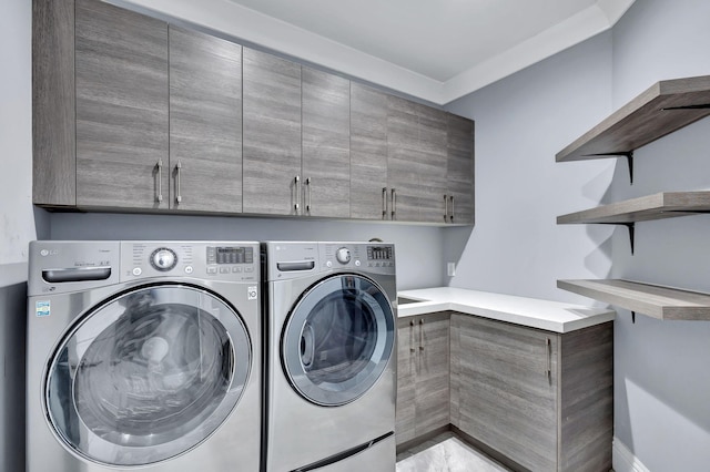 washroom featuring cabinets and washing machine and dryer