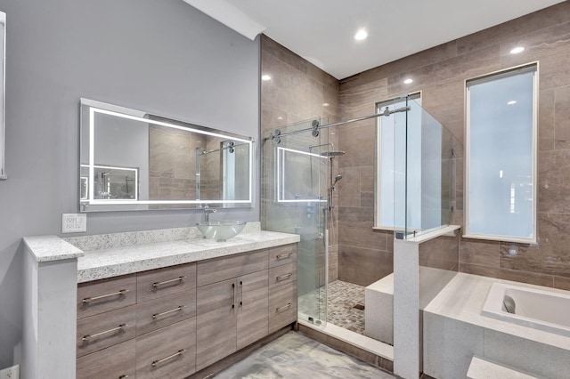 bathroom with separate shower and tub and vanity